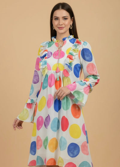 Woman wearing a colorful polka dot dress against a beige background